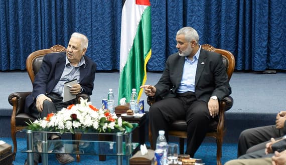 Hamas prime minister in Gaza Haniyeh gestures during a meeting with Nasir, chairman of the Palestinian Central Election Commission in Gaza City