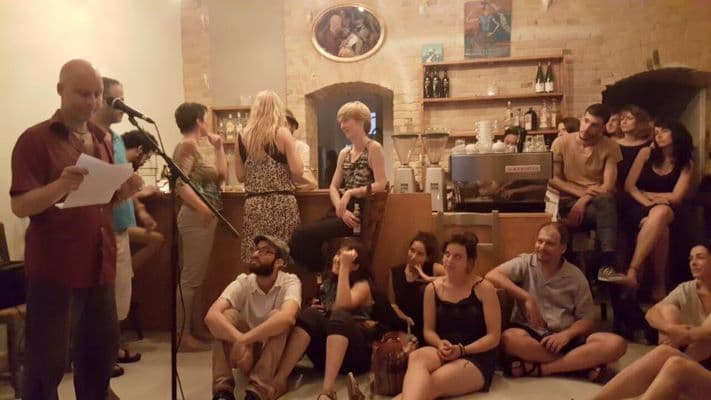 Listening to a reading at Cafe de Bagh