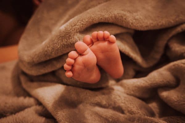 small feet wrapped in a blanket