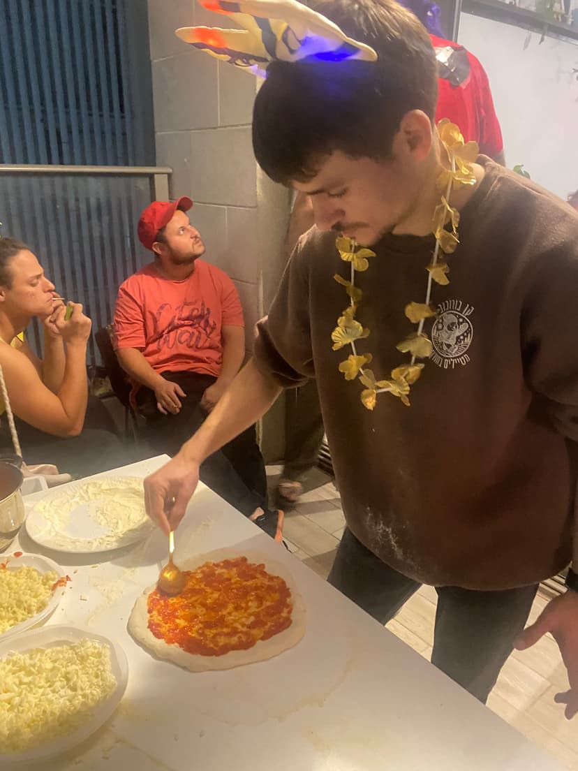 A costumed partygoer makes pizza (supplied)