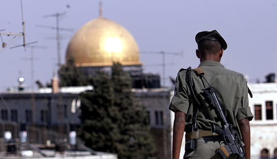 ISRAELI BORDER POLICEMAN KEEPS WATCH OVER THE OLD CITY OF JERUSALEM.