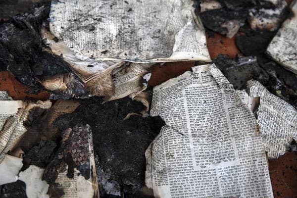 Burned Talmud books in the synagogue of the Maoz Military Preparation Program after it was damaged by fire during clashes in Lod, May 14 (AP/Heidi Levine)