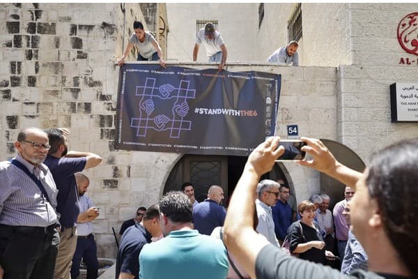 <strong>Palestinian activists protest against the Israeli raid of the Al-Haq offices in Ramallah (Abbas Momani/AFP)</strong>