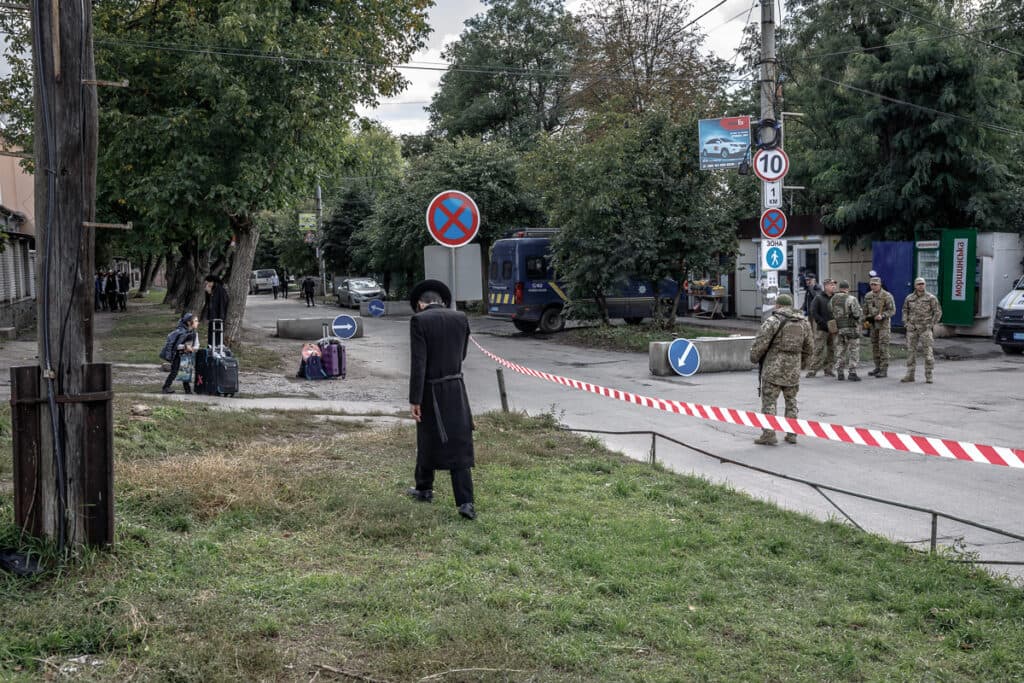 A Hasid arriving in Uman approaches the military checkpoint