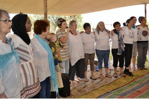 The meeting ends in a circle of songs of peace