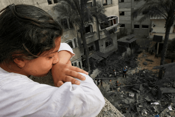 A Palestinian girl surveys the damage to buildings in Gaza (Mohammed Abed/AFP)