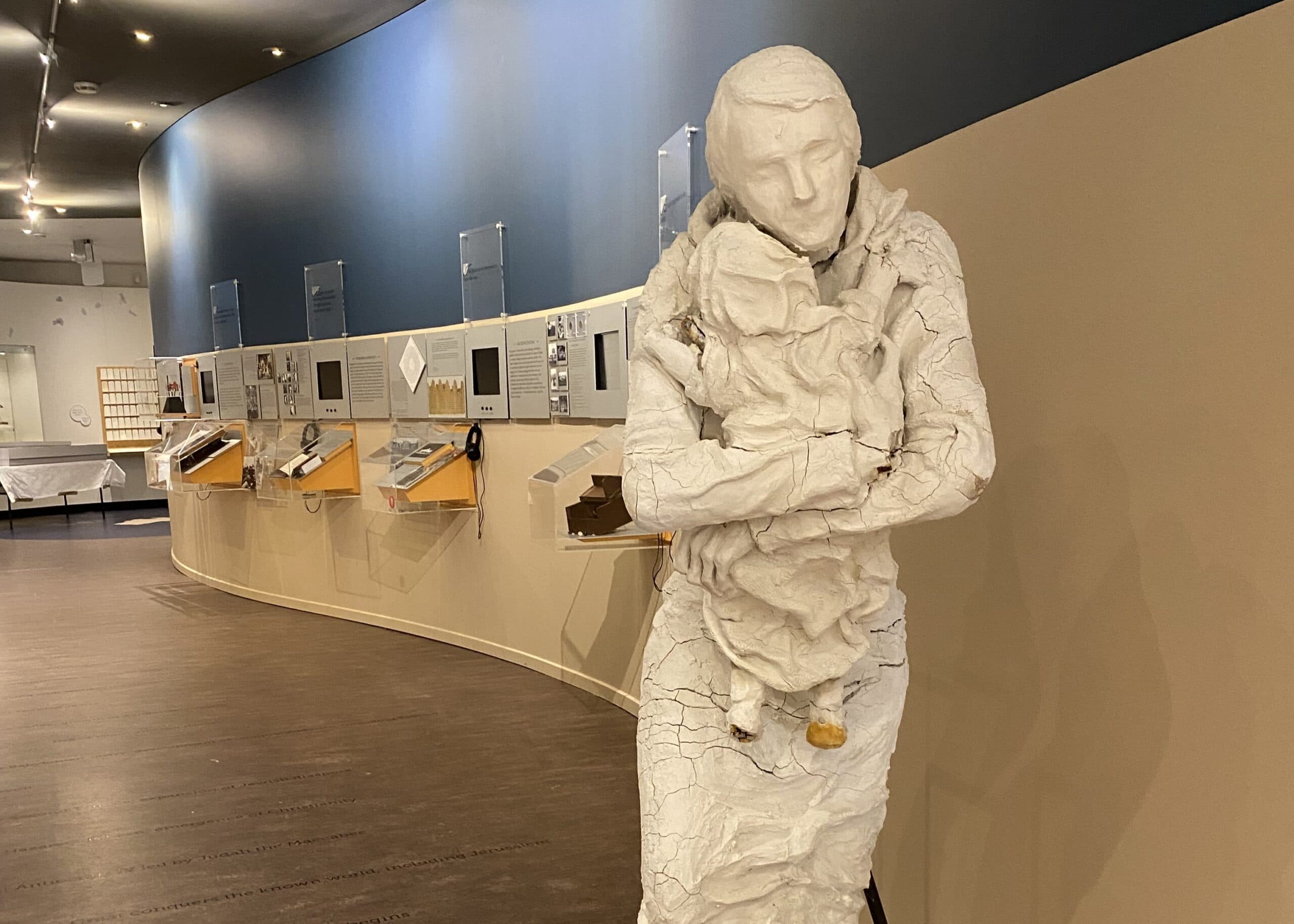Large ceramic artwork of a mother holding her baby