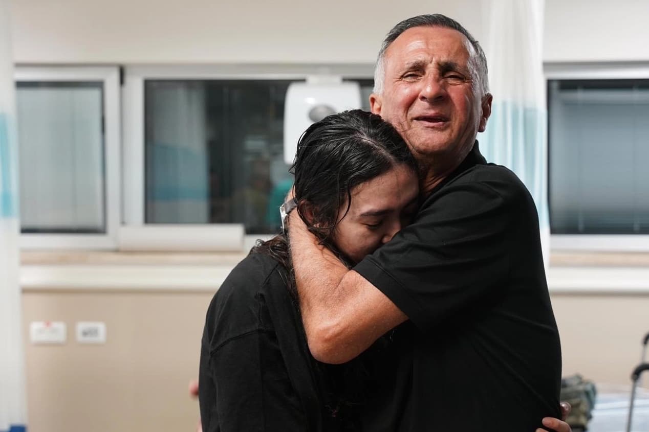 Older man embracing young woman.