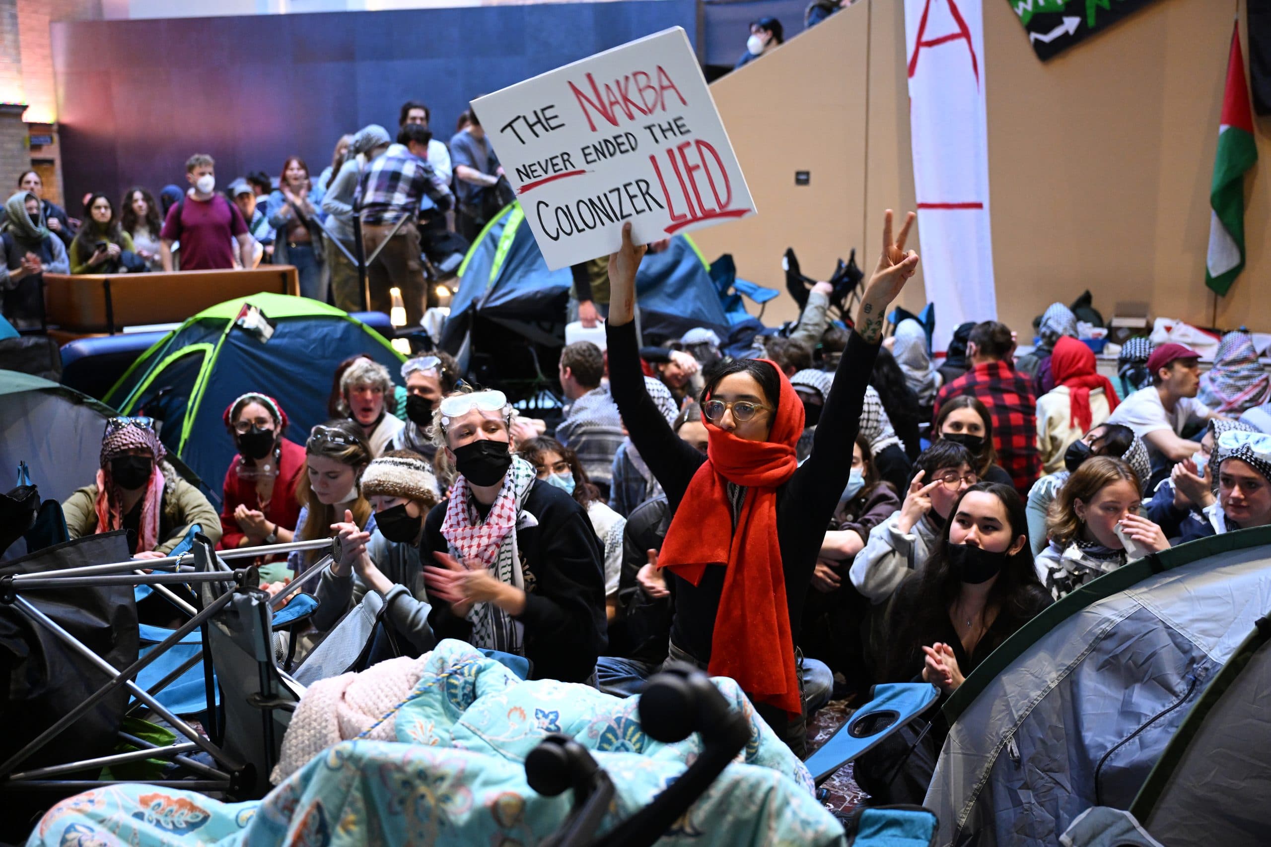 Protesters congregate inside a building during a Pro-Palestine rally at the University of Melbourne