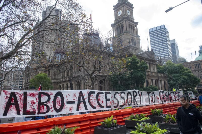 Banner reading "Albo accessory to Gaza"