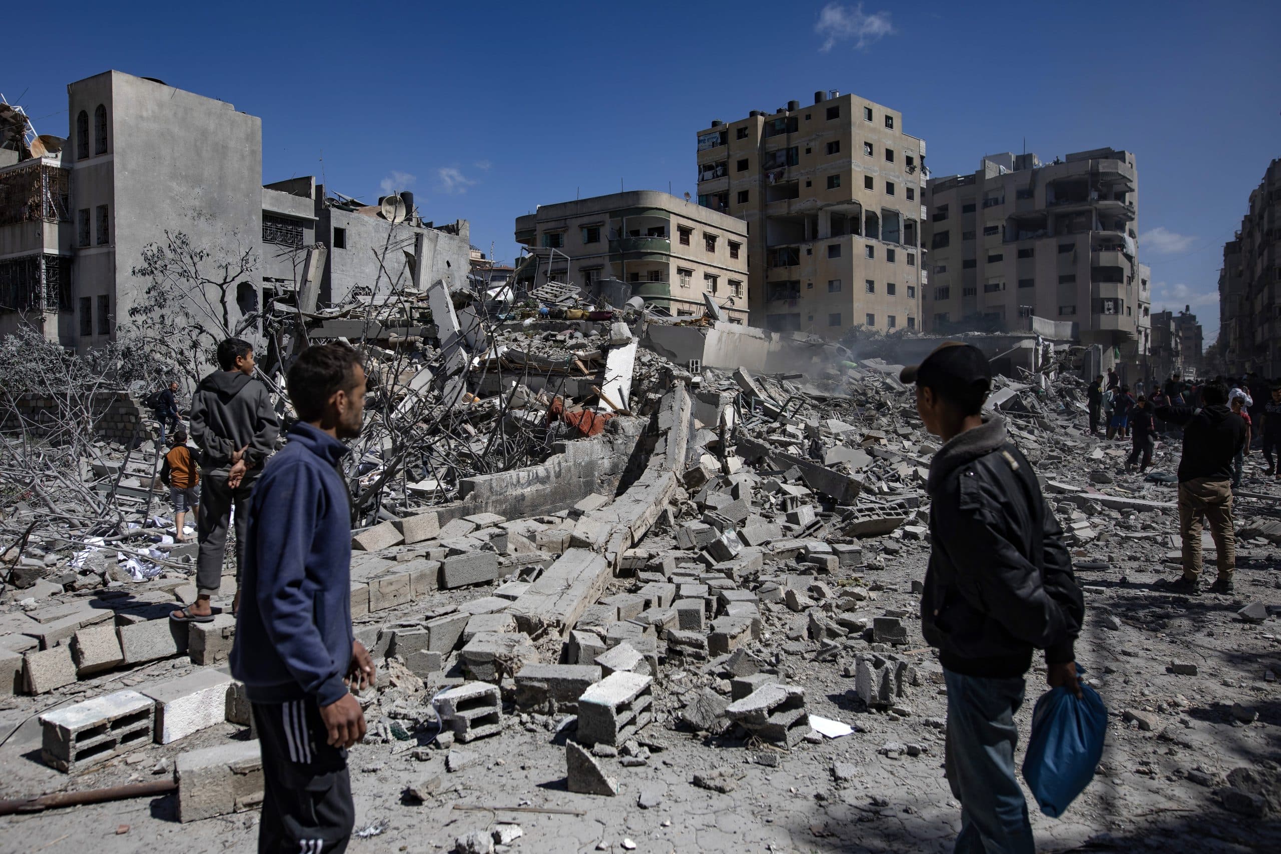Palestinians inspect a destroyed house after an Israeli airstrike in Gaza City