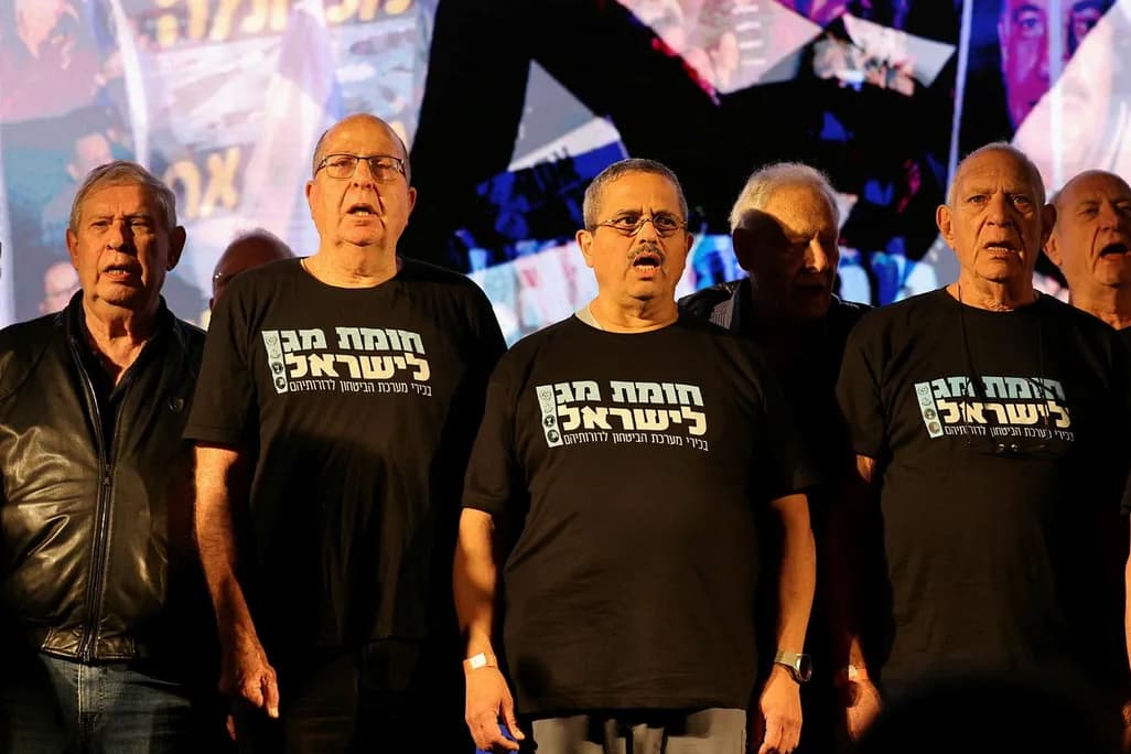Old men in black t shirts with Hebrew writing