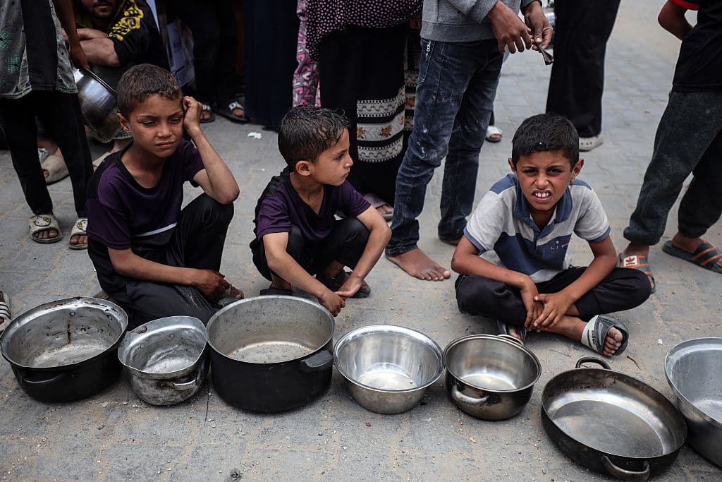3 boys with empty metal bowls