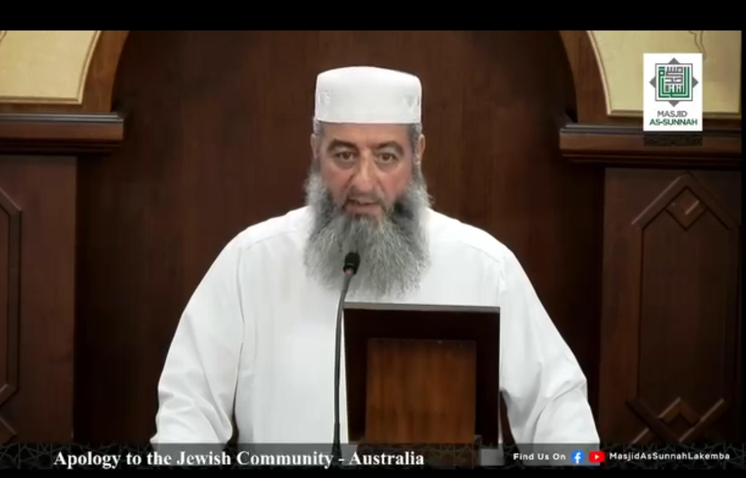 Man in white robe and hat