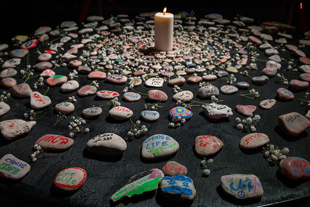 painted stones surrounding a candel