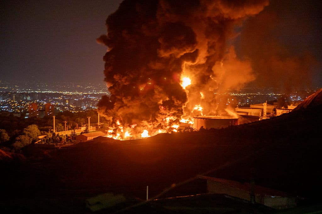 Fire and smoke rise into the sky after an Israeli attack on the Shahran oil depot