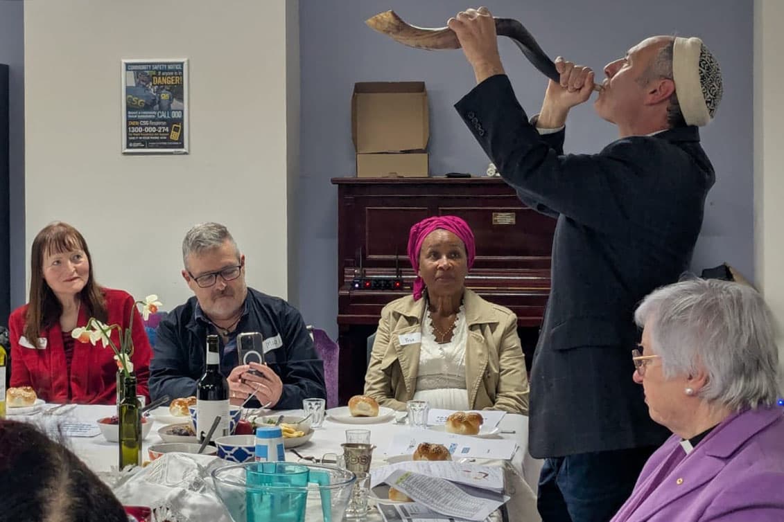Rabbi Yonatan Sadoff sounds the shofar at a multicultural Rosh Hashanah seder.