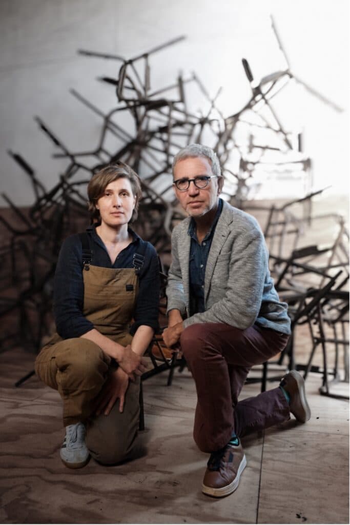 Sanadze and Ben-Moshe with burnt chairs salvaged from the Adass Israel synagogue (Image: Belle Stewart).