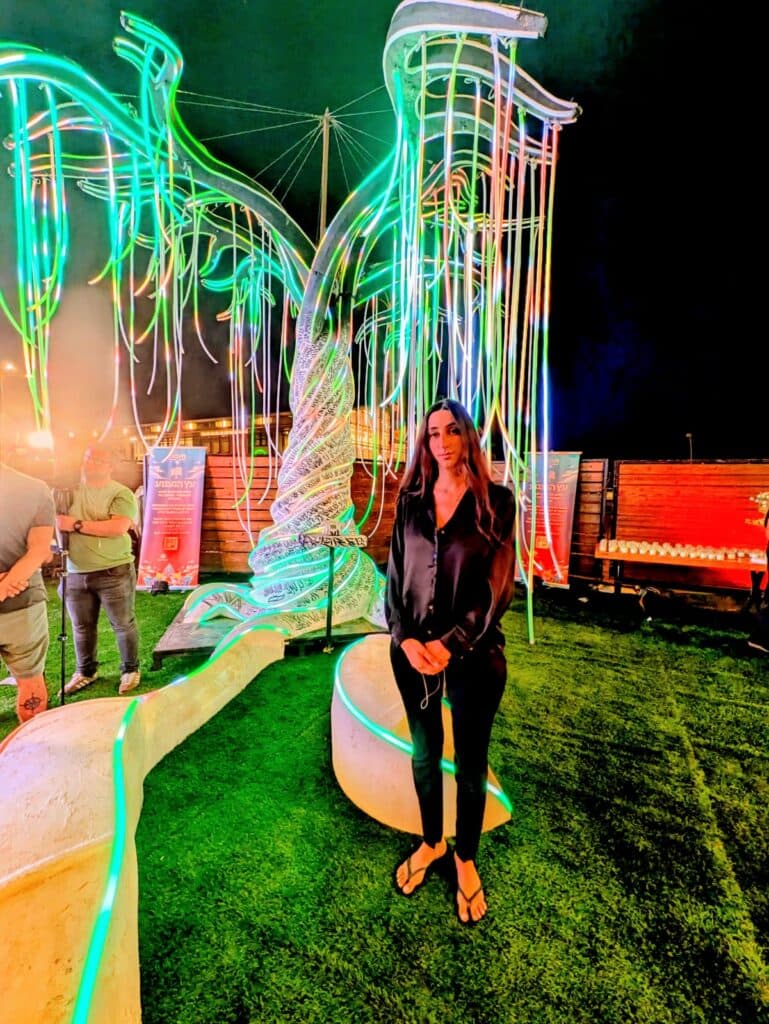 Tali Binar standing by the installation, "The tree for those we are missing."(Eetta Prince -Gibson)