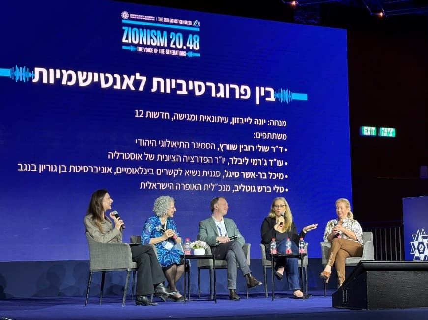 Jeremy Leibler (centre) and Professor Michal Bar-Asher Siegal (second from right) debate onstage (Ittay Flescher)