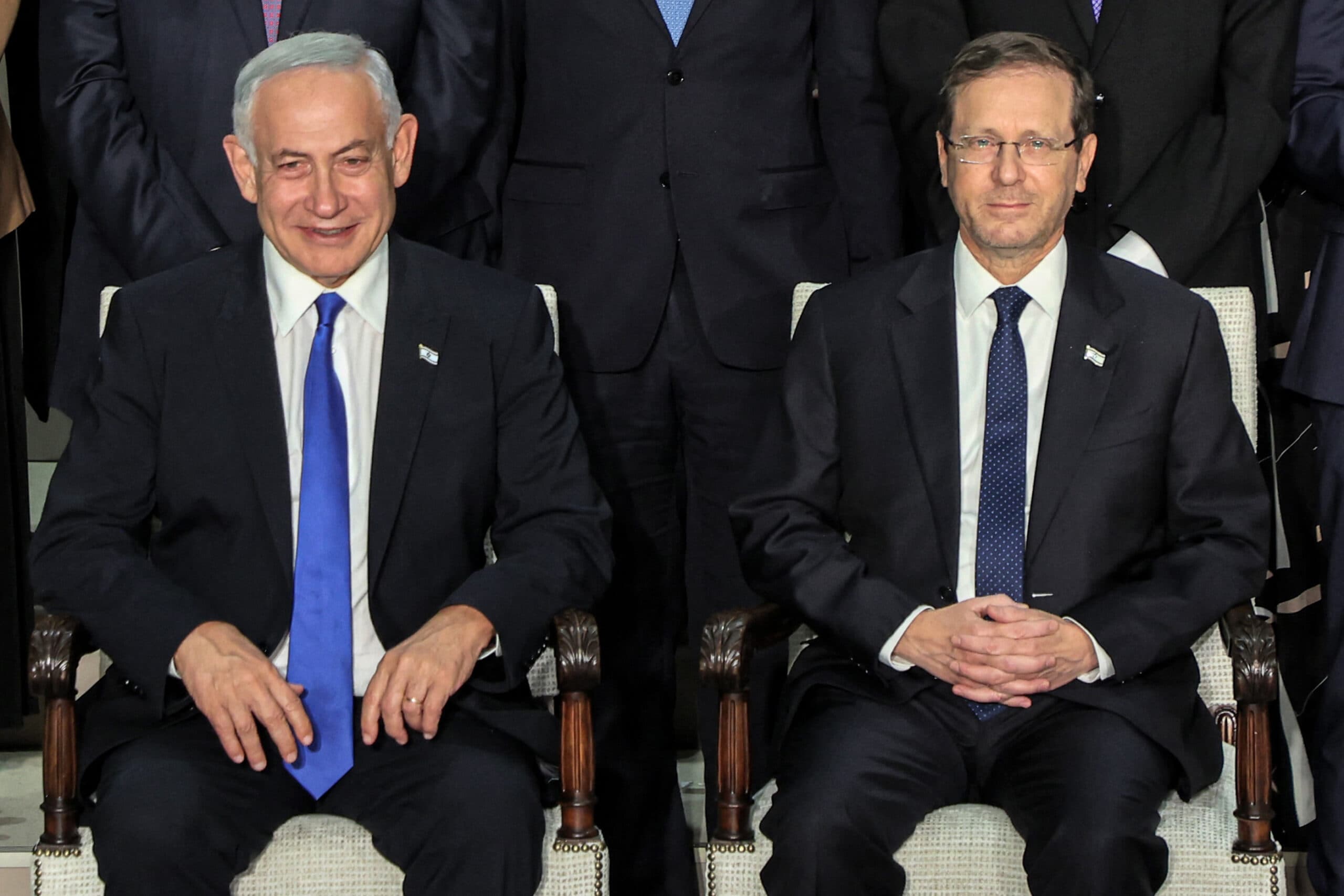 Two men in suits and ties in a formal pose.