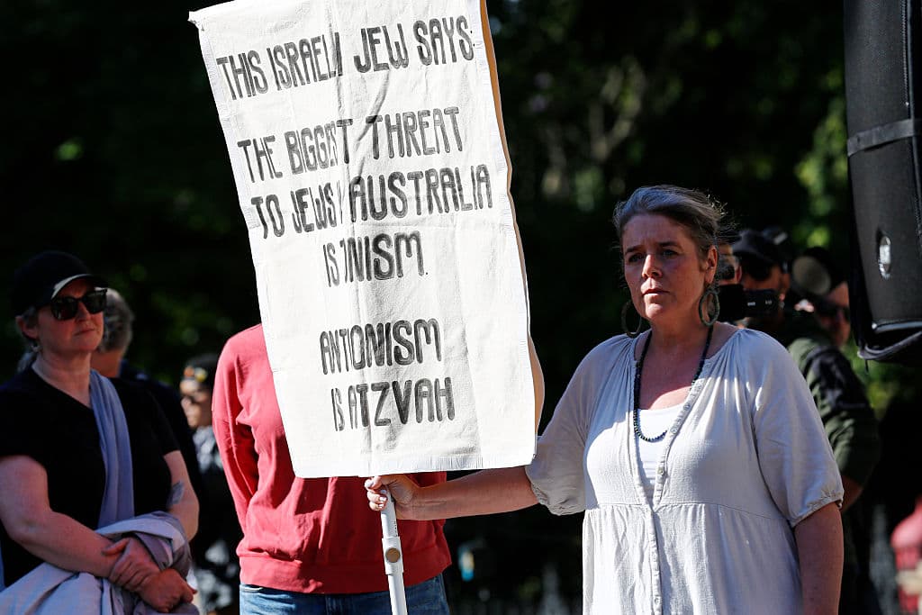 A protester holds a placard expressing her opinion during