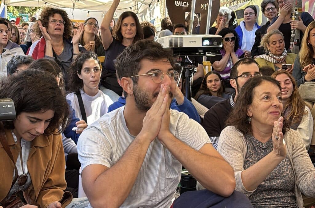 Israeli campaigners watch the release of the last living hostages on October 13 2025 (Ittay Flescher)