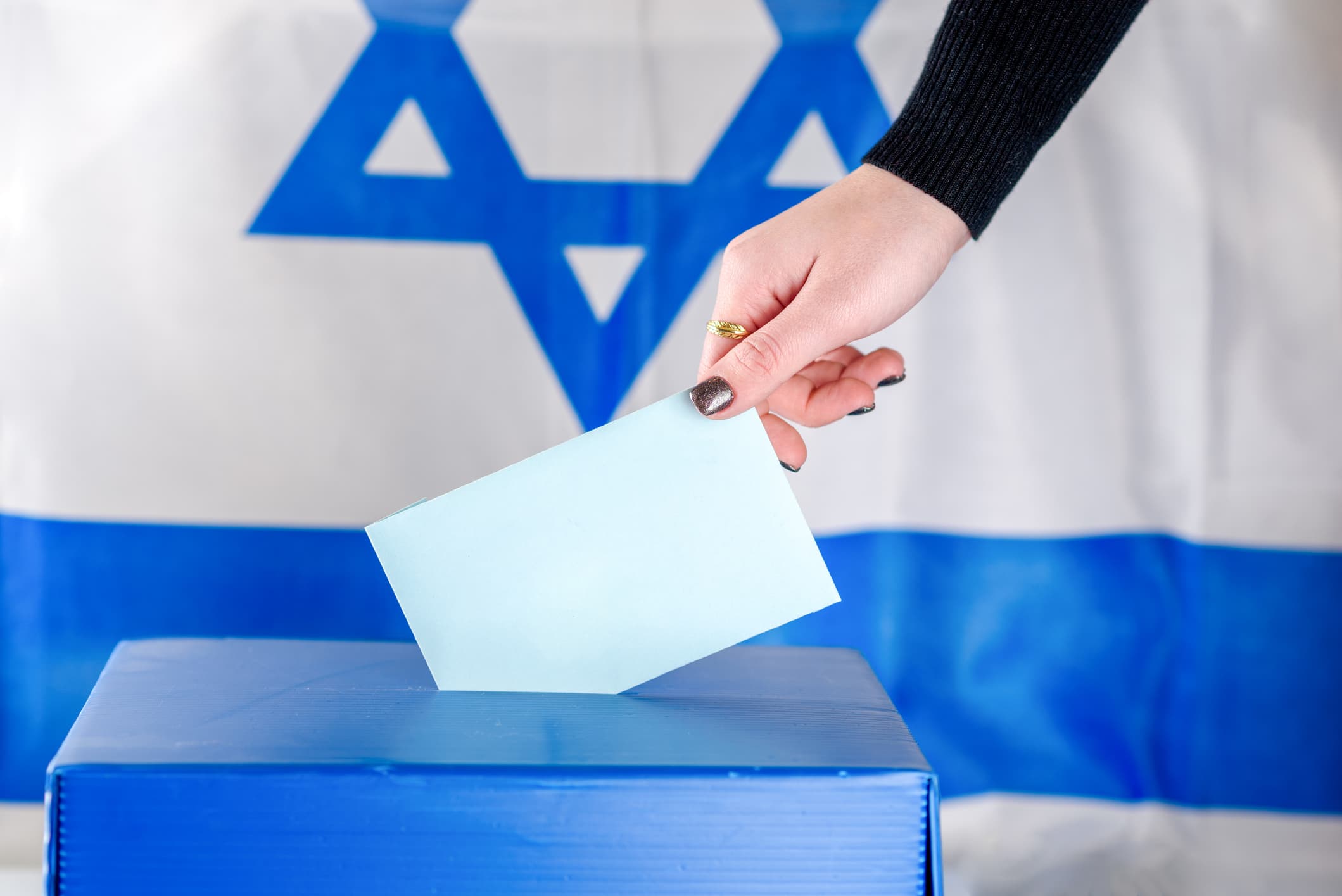 Israel election ballot boxi Young woman putting a ballot in a ballot box