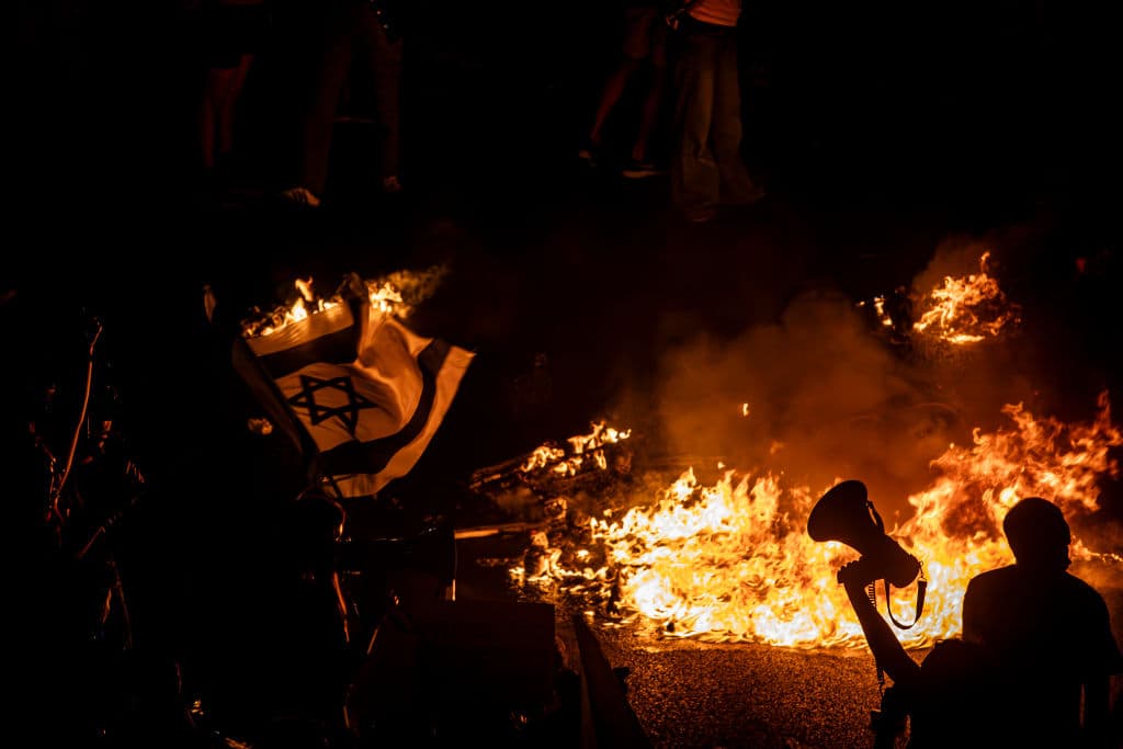 Israeli protest flag fire