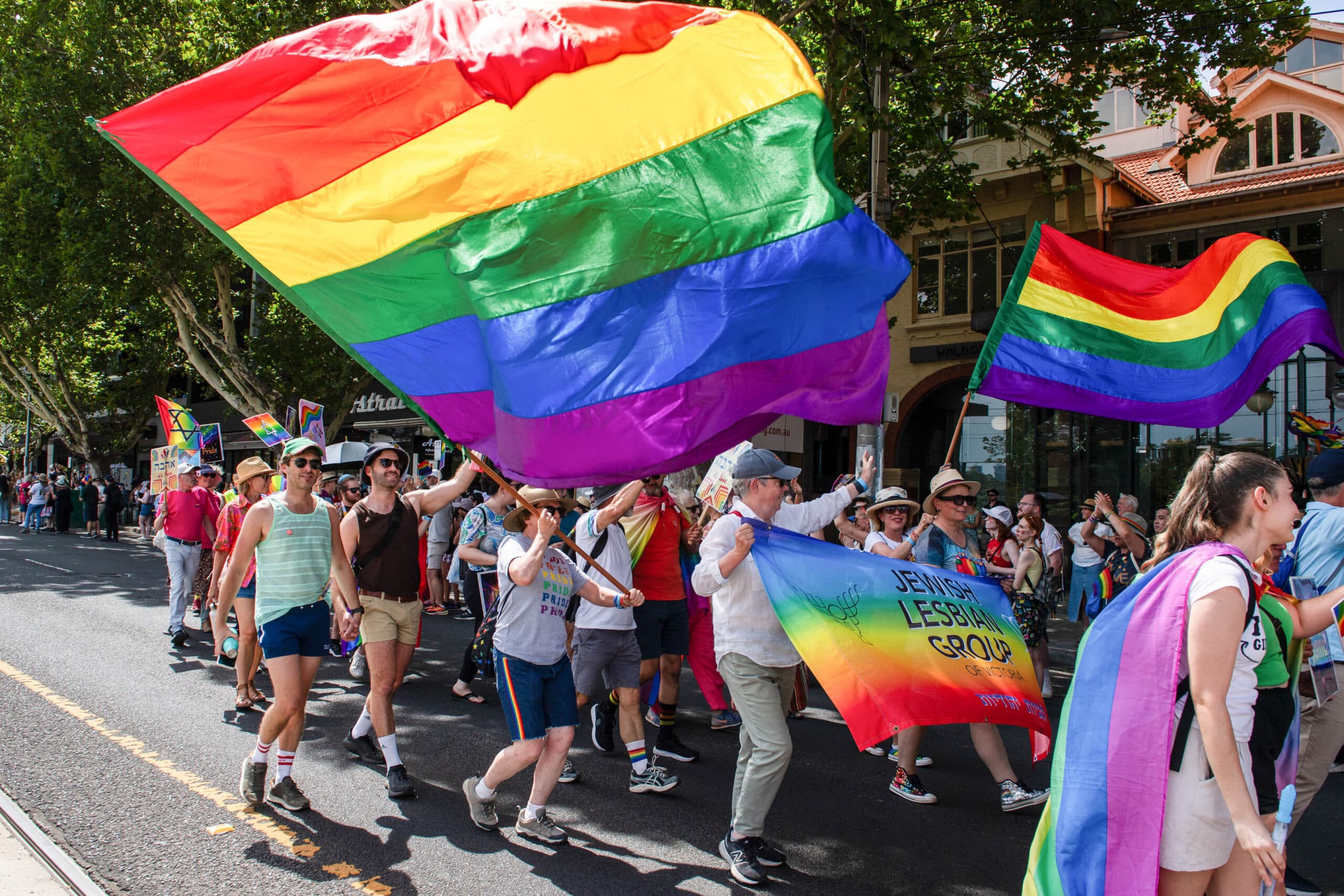 Jewish members of the LGBTQ+ march in pride carrying rainbow