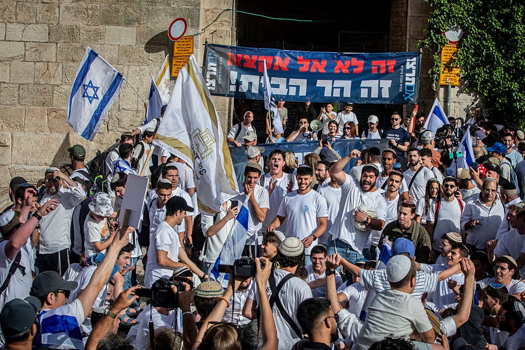 Israeli right wing youths wave their national flags outside