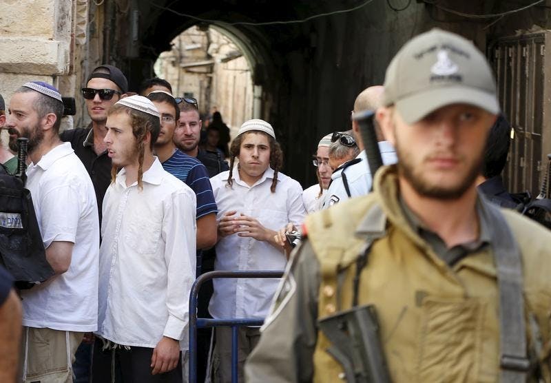 Israeli policemen stand guard as a group of Jewish youths leave after visiting the compound which houses al-Aqsa mosque in Jerusalem’s Old City