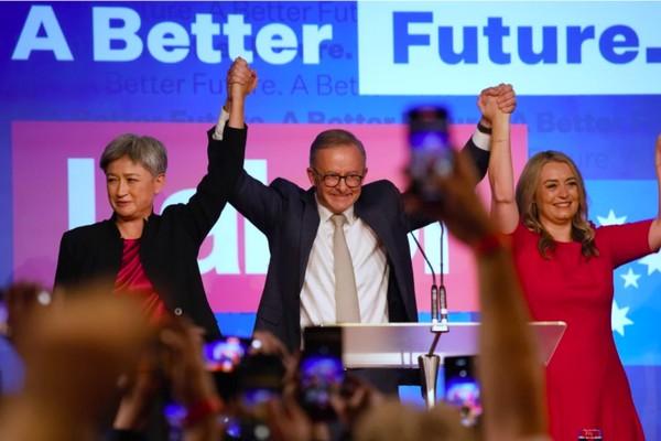 Anthony Albanese celebrates victory with Penny Wong (left) and his partner Jodie Haydon (Rick Rycroft/AAP)