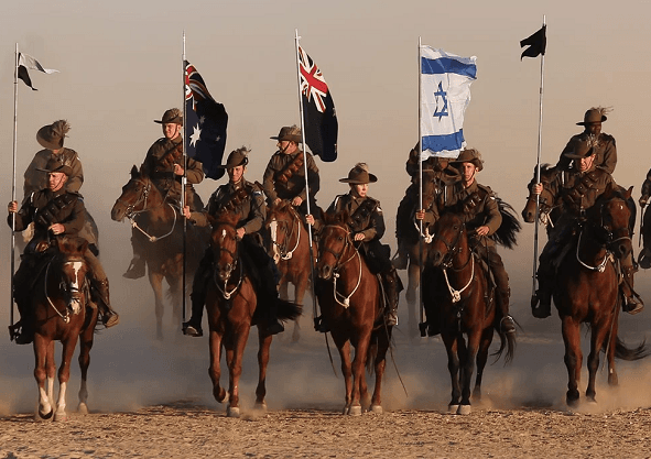 Australian Mounted Division and New Zealand Mounted Division soldiers ride their horses during the reenactment of the Battle of Be’er Sheva in 2017 (Ilan Assayag/ Haaretz)