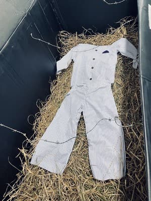 Life-sized replica of clothing worn in camps.