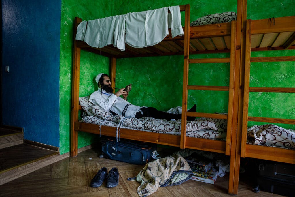 A man with a shofar on his rented bunk in Uman