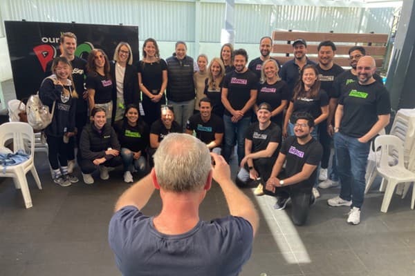 Steve, a volunteer, takes a happy snap of the DocuSign group (Peter Fray)