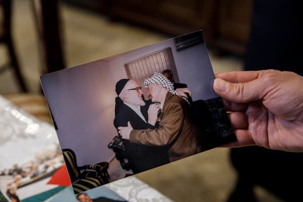 Rabbi Meir Hirsch, leader of Neturei Karta, holds a photo of his father, the founder of the movement, with PLO leader Yasser Arafat