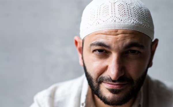 Bearded man wearing a skullcap.