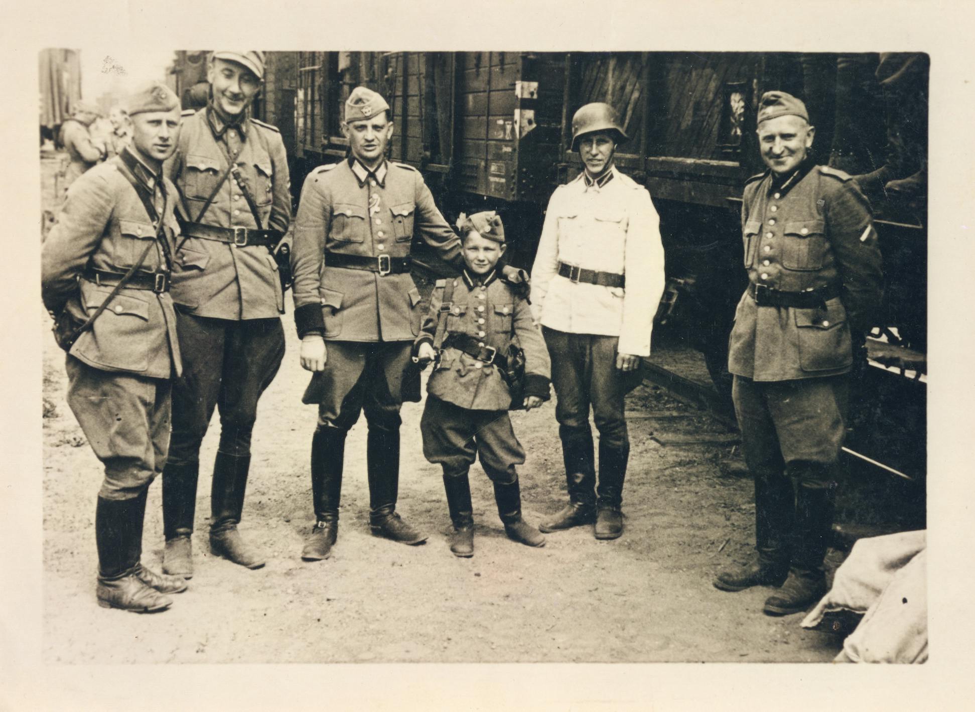 Young Alex Kurzem stands with Latvian SS batallion in a black and white image