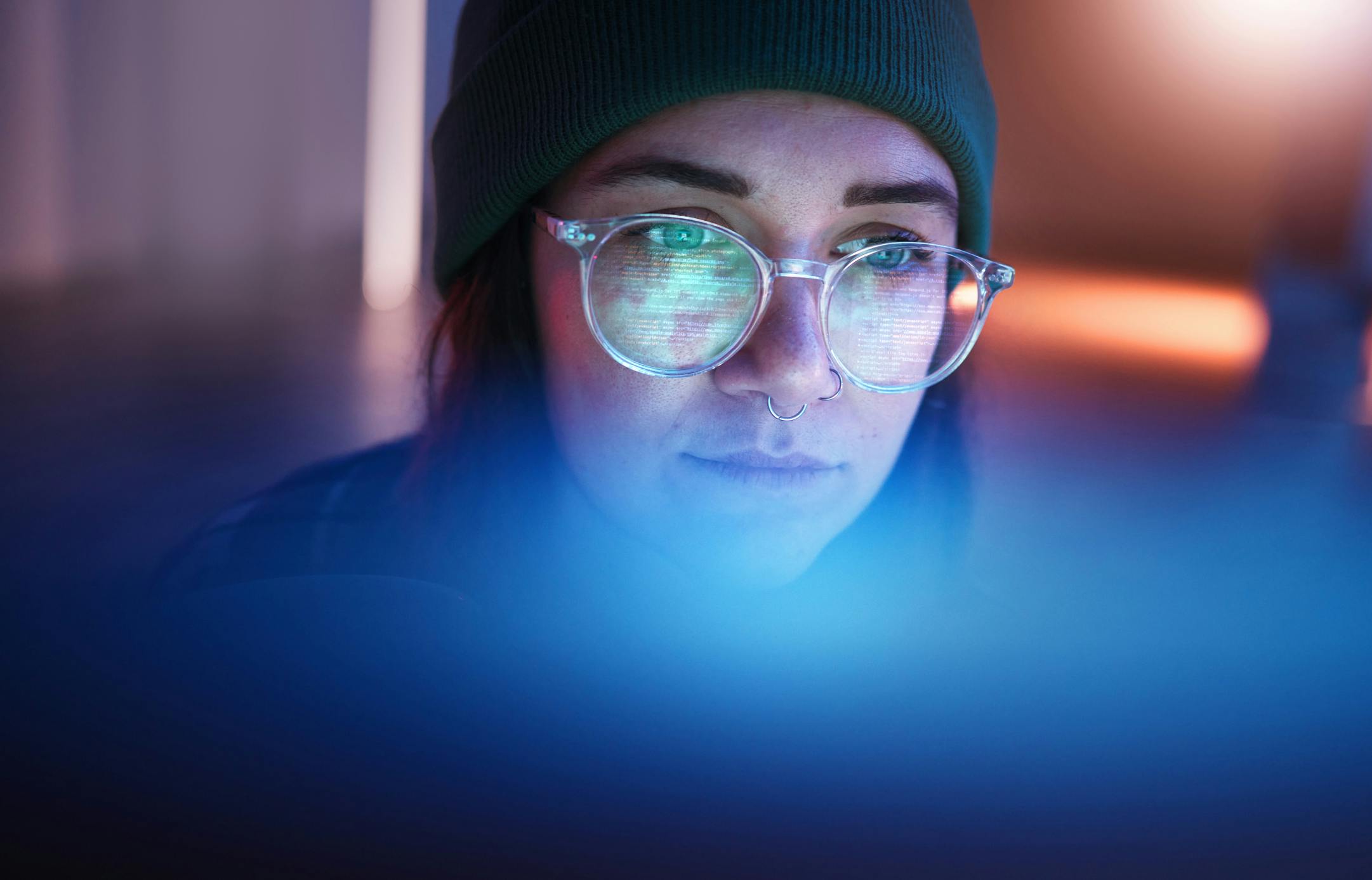 woman with blue screen reflected in her face