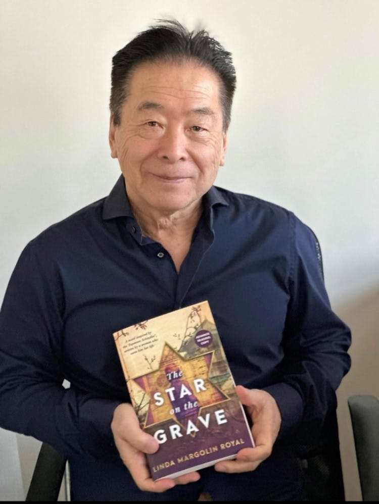 Nobuki Sugihara, the only surviving son of Chiune Sugihara, with Royal’s book The Star on the Grave (Image: Supplied).