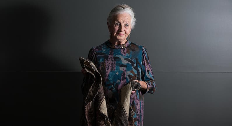 White haired woman holding a blanket