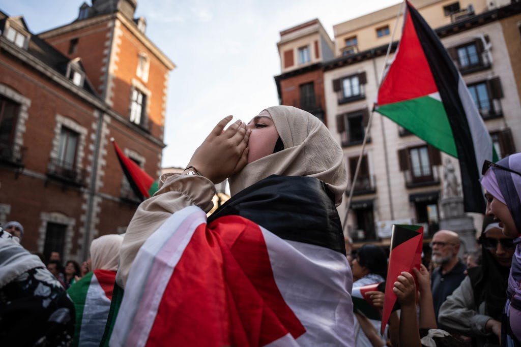 Woman wrapped in a Palestinain flag