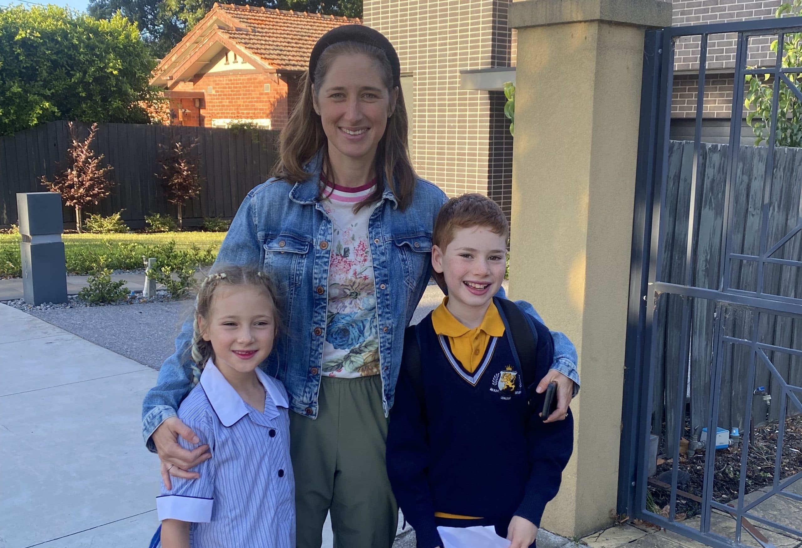 Woman with two children in school uniform