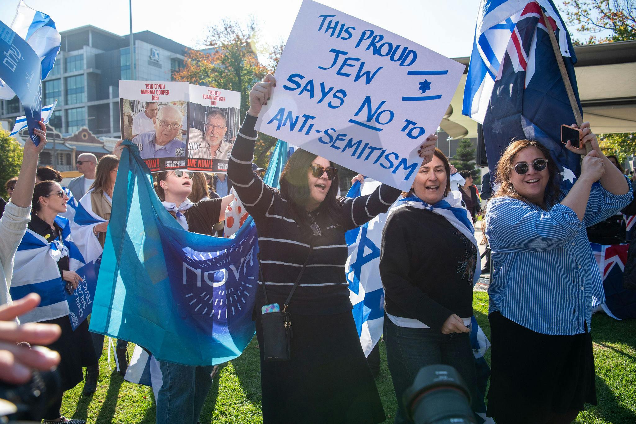 Pro-Israel protesters hold sign reading 'This proud Jew says no to antisemitism'