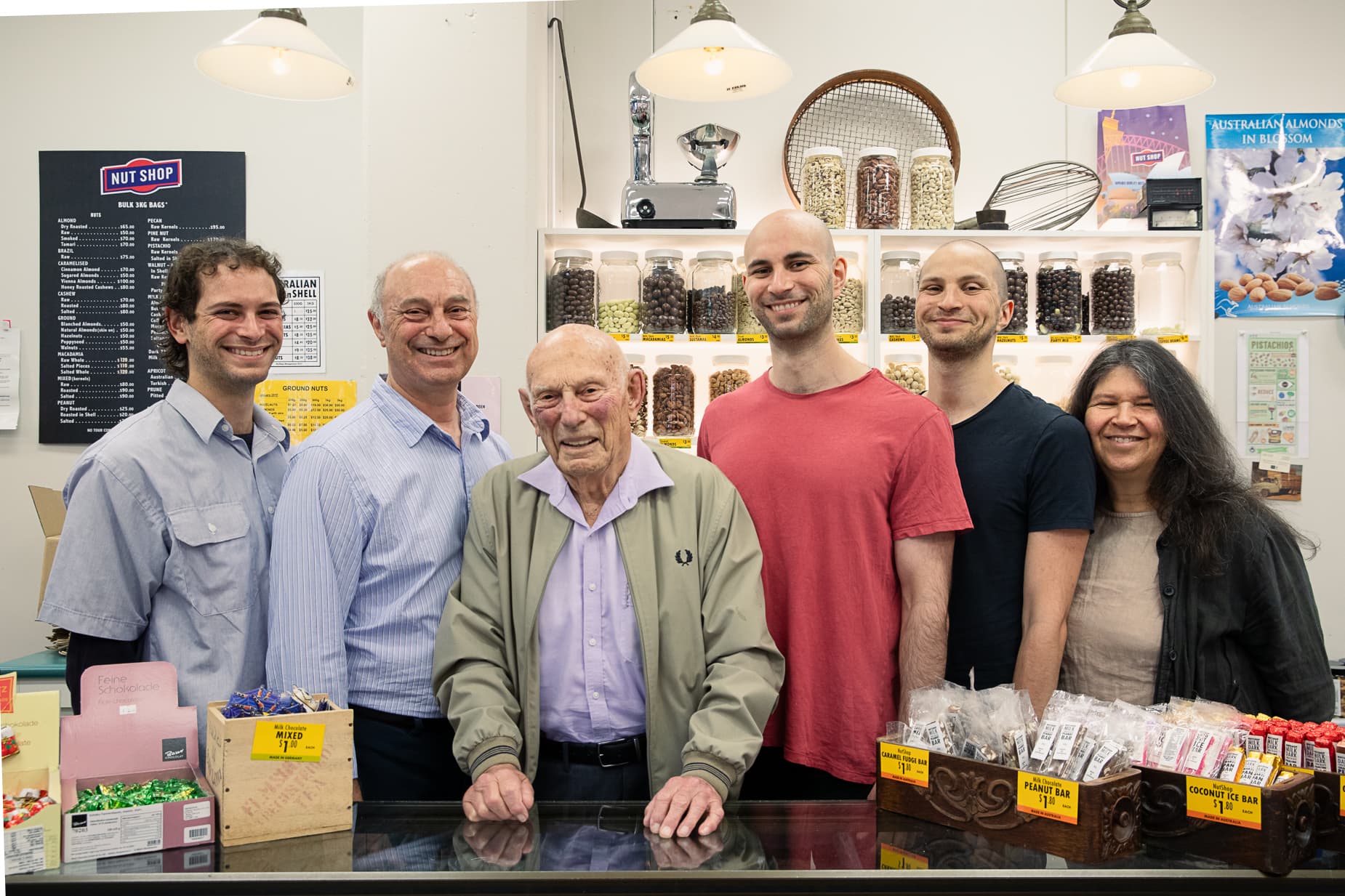 Six people at a shop counter