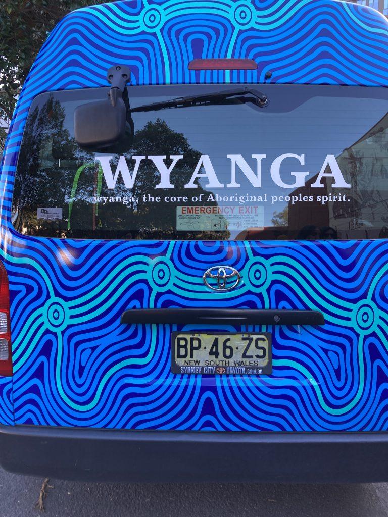 A passing vehicle is part of the wealth of Indigenous culture in the Sydney suburb