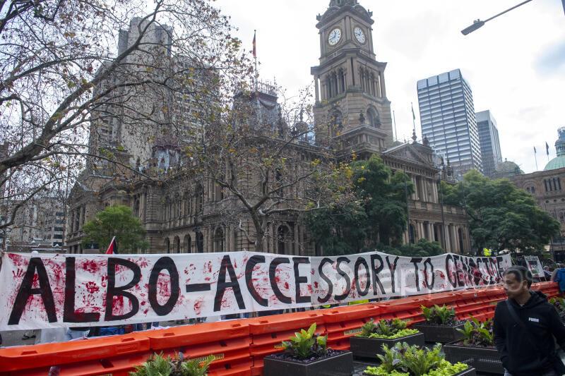 Banner reading "Albo accessory to Gaza"