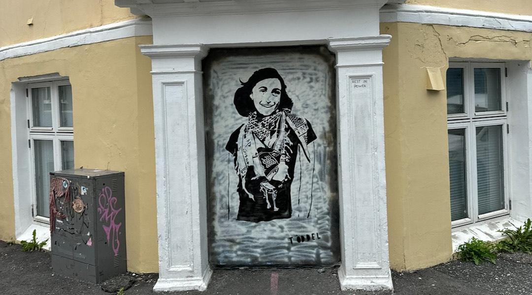 A mural of Anne Frank wearing a keffiyeh